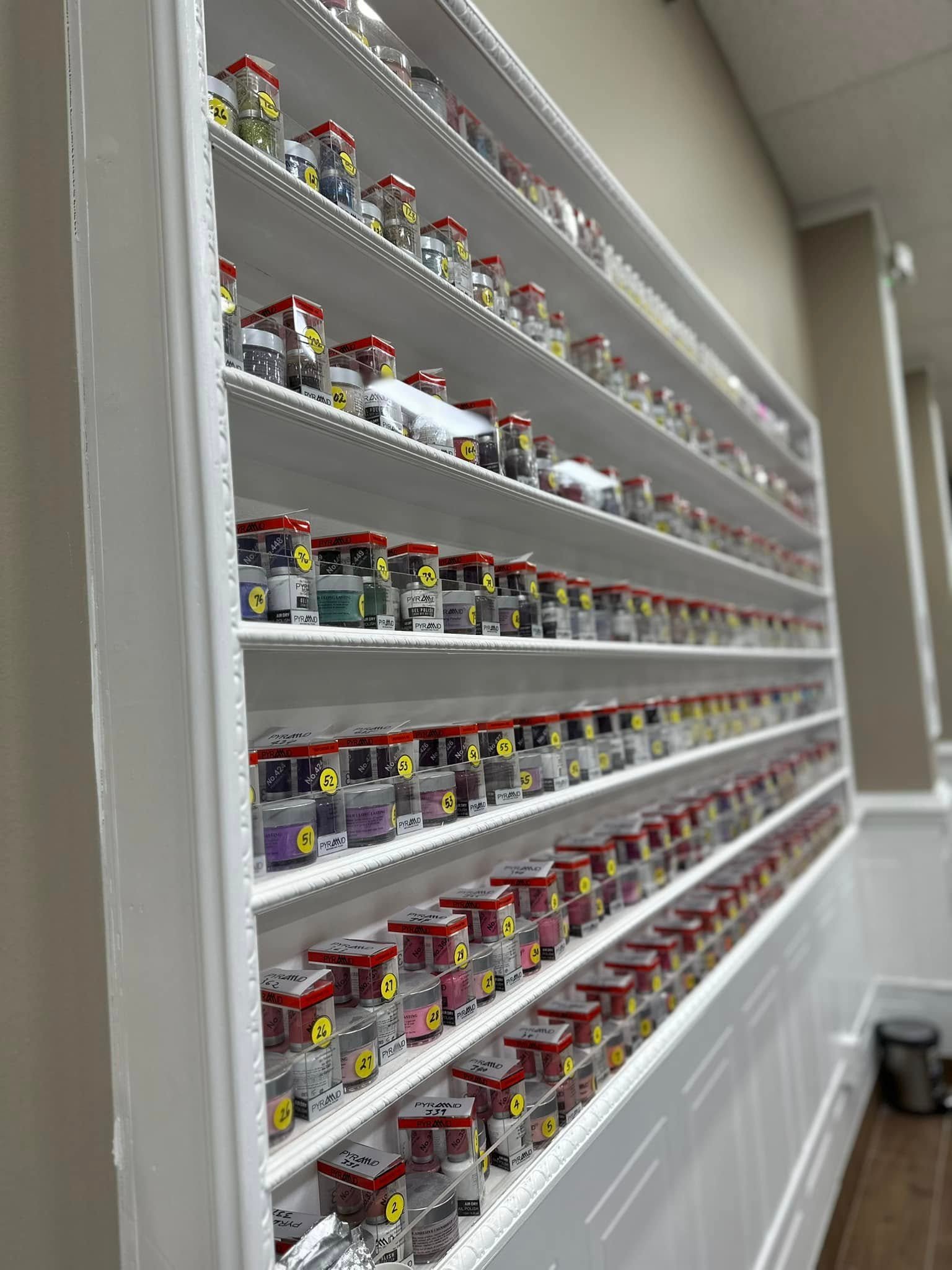 Extensive wall display of dip powder color options at LaVie Nails